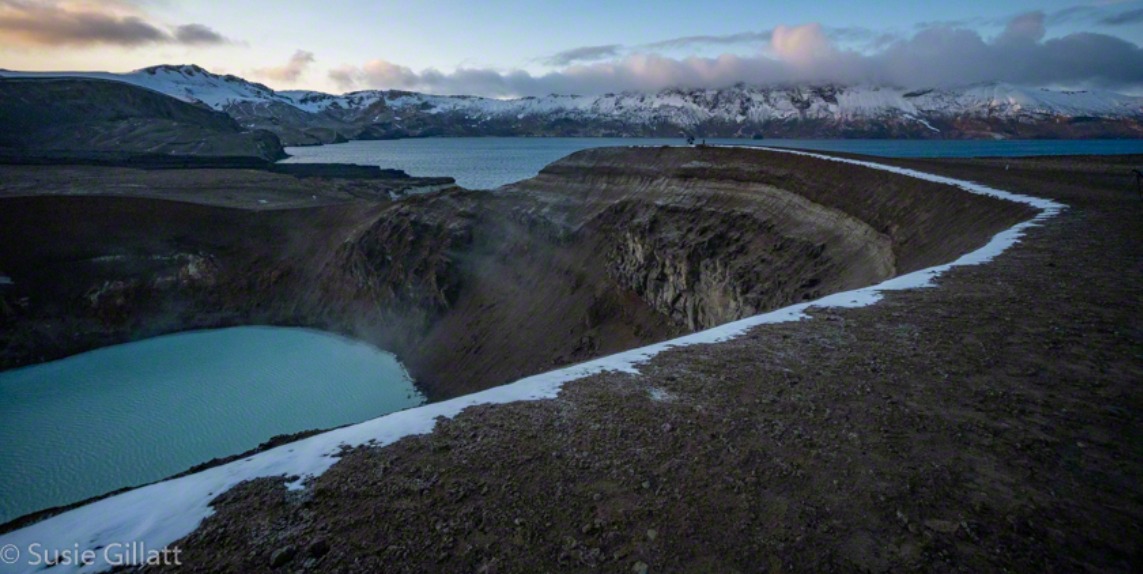 volcanic crater with a lake at sunrise